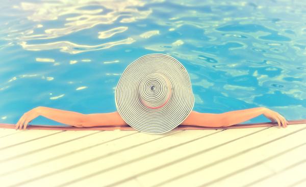 Woman on Vacations with Hat Relaxing -Swimming Pool