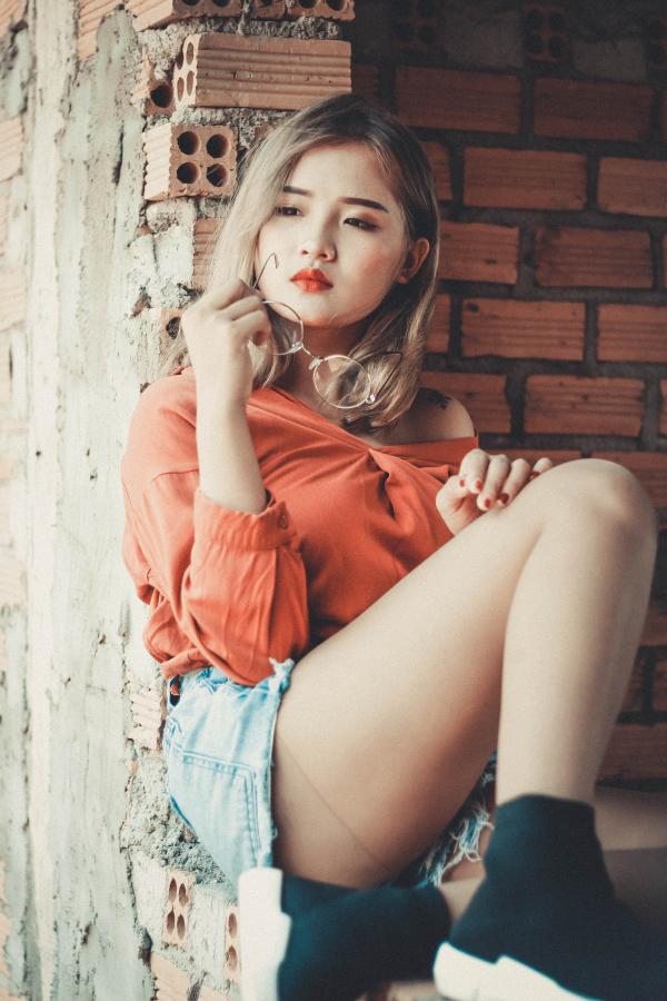 Woman Sitting on Concrete Ground