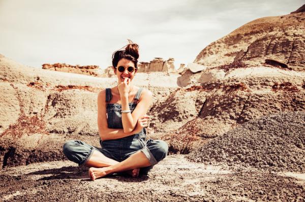 Woman Smiling Wearing Denim Dungarees and Sunglasses