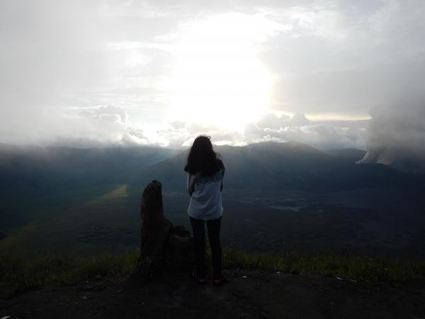 Woman Staing at the Edge of the Mountain Facing the Sun