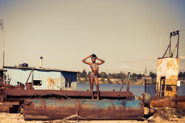 Woman Standing on Brown Steel Container Wearing Two-piece Bikini
