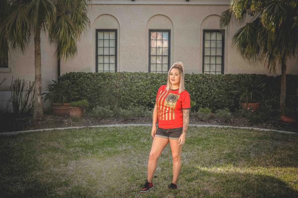 Woman Standing on Grass Field in Front of House