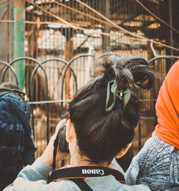 Woman Taking Photograph Using Canon Dslr Camera