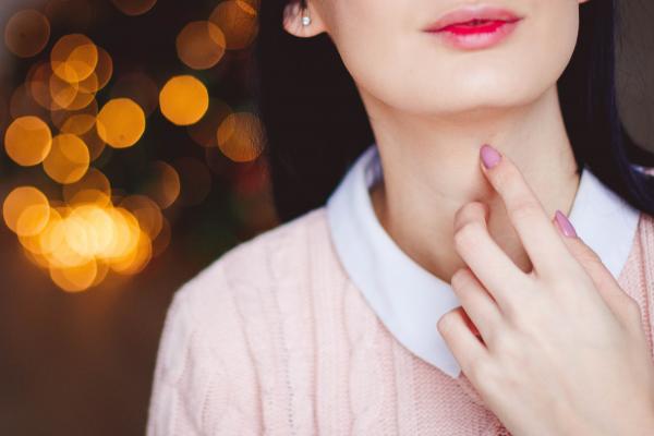 Woman Touching Neck
