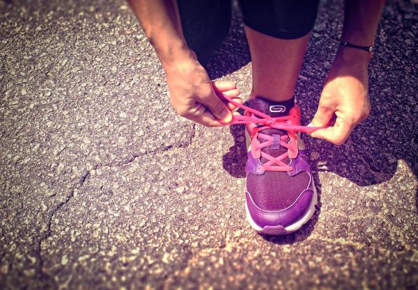Woman Tying Shoe Laces