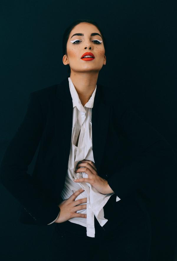 Woman Wearing Black Formal Suit Jacket Doing Pose