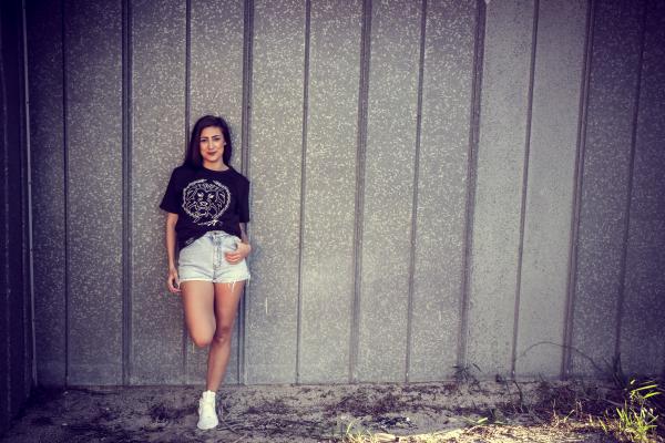 Woman Wearing Black Shirt Leaning on Wall