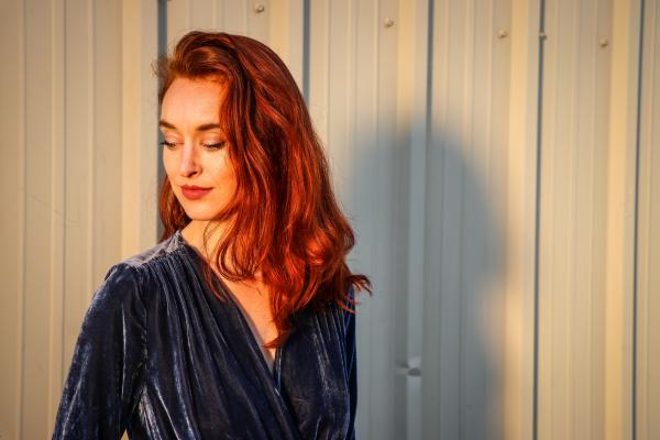 Woman Wearing Blue Top Looking Downward