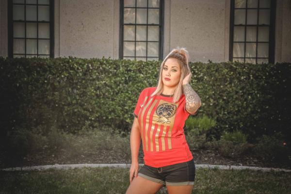 Woman Wearing Brown and Red T-shirt Standing Near the House