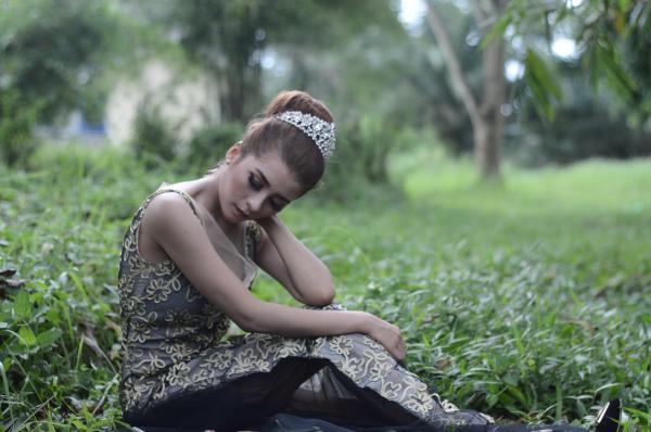 Woman Wearing Brown and White Sleeveless Floral Embroidered Dress Sitting on Green Grass Field