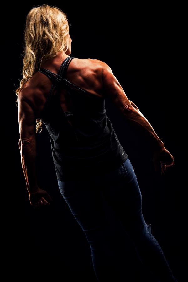 Woman Wearing Criss Cross Back Strap Top Flexing