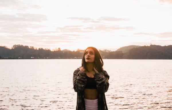 Woman Wearing Jacket Standing Near The Ocean
