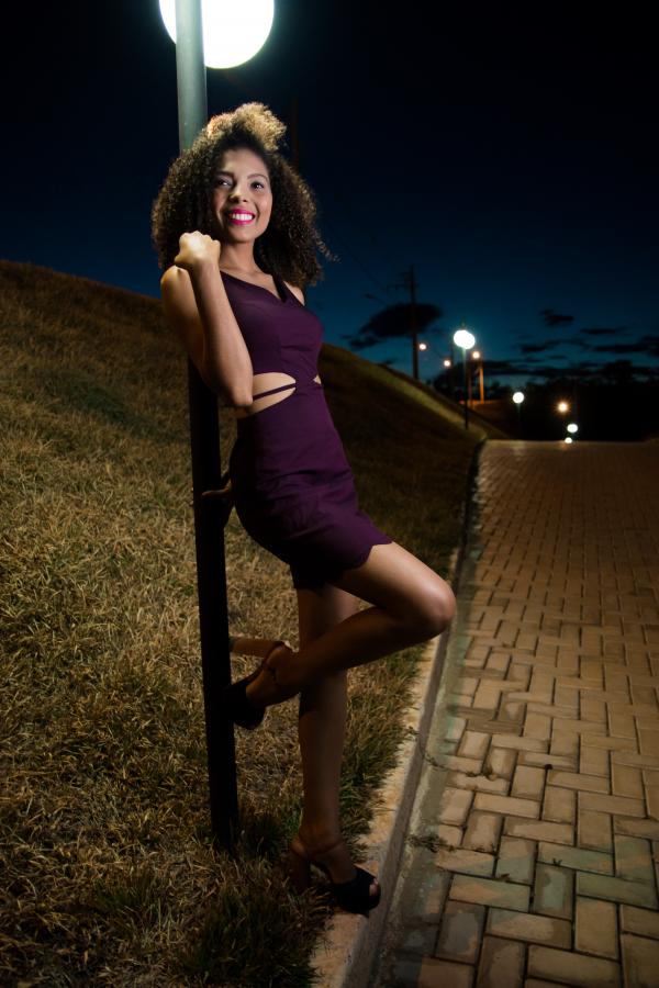 Woman Wearing Purple Dress Behind Gray Pole Photo