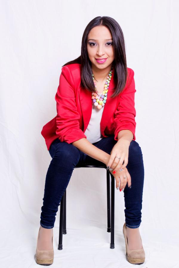 Woman Wearing Red Blazer Sitting on Black Stool