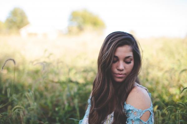 Woman Wearing Teal Off Shoulder While Seating on Grass Photo