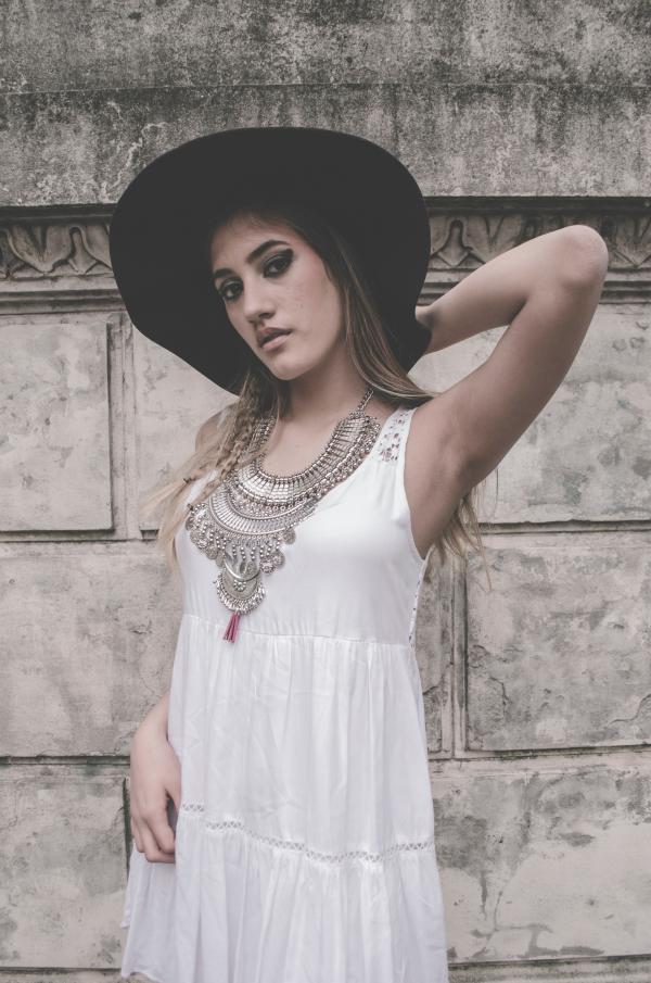 Woman Wearing White Sleeveless Dress With Hands on Back