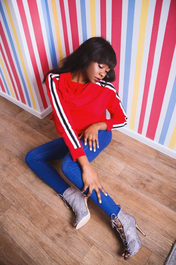Woman With Red Long-sleeved Shirt Sitting on the Floor Looking Down