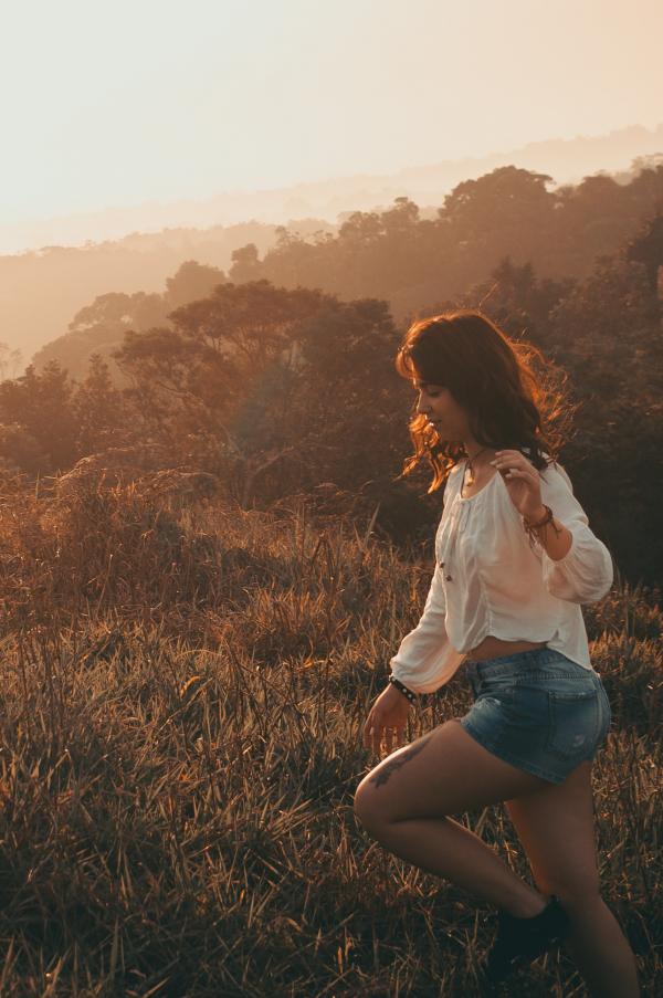 Women Wearing White Long-sleeved Blouse With Blue Denim Short Shorts Taken during Sunset
