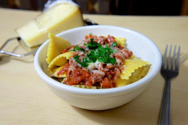 Yellow Baked Pasta on White Ceramic Bowl on Beige Surface