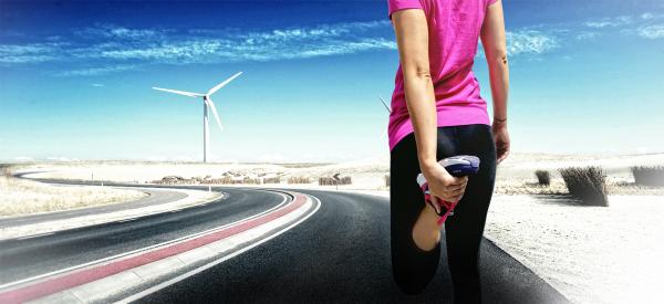Young Female Runner Stretching before Jogging