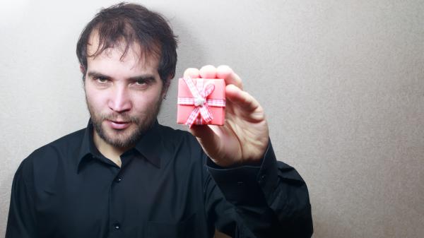 young man holding a gift