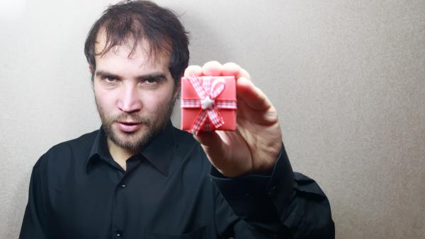 young man holding a gift