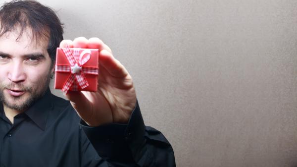 young man holding a gift