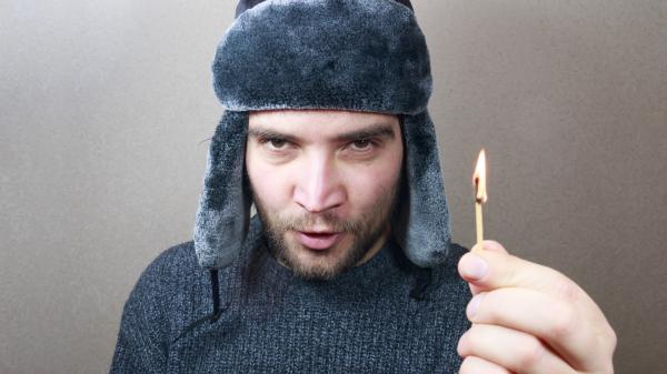 Young man holding a match