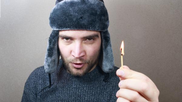 Young man holding a match